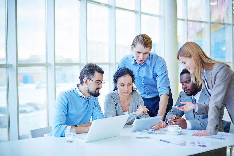Professionals discussing a project around a table